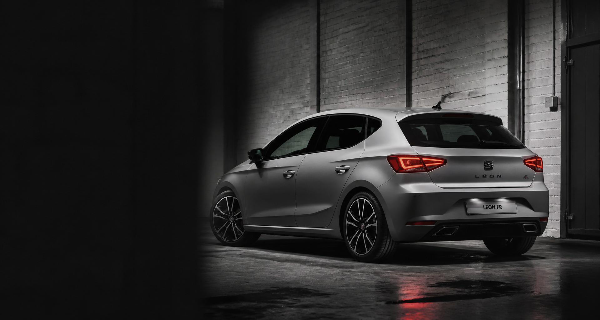 Silver Seat Leon FR parked in a moody industrial garage